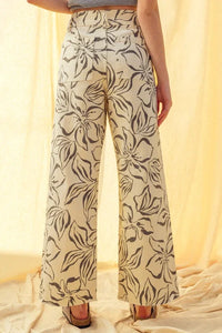 Floral print stretch wide leg pants in beige with black floral pattern