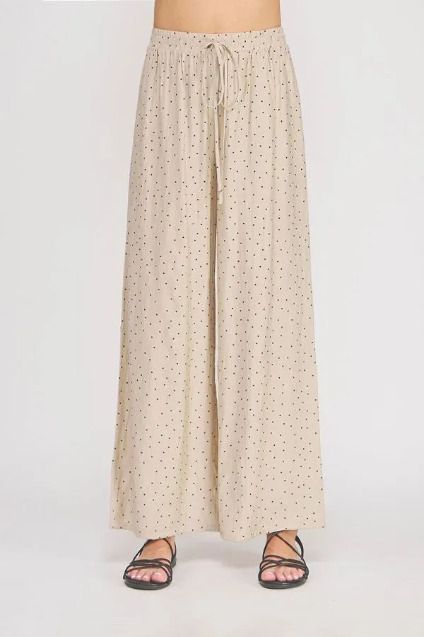 Beige dots textured wide leg pant with subtle black polka dot pattern and elastic waistband for comfort