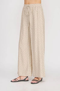 Beige wide leg pant with dots textured wide pattern and elastic waistband with matching drawstring