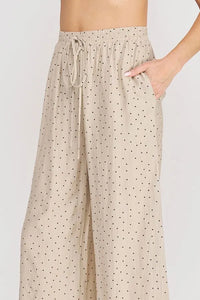 Beige dots textured wide leg pant with black polka dots elastic waistband and matching drawstring