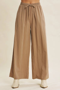 Beige wide leg pants with elastic waistband and drawstring in a step washed fabric for comfortable wear