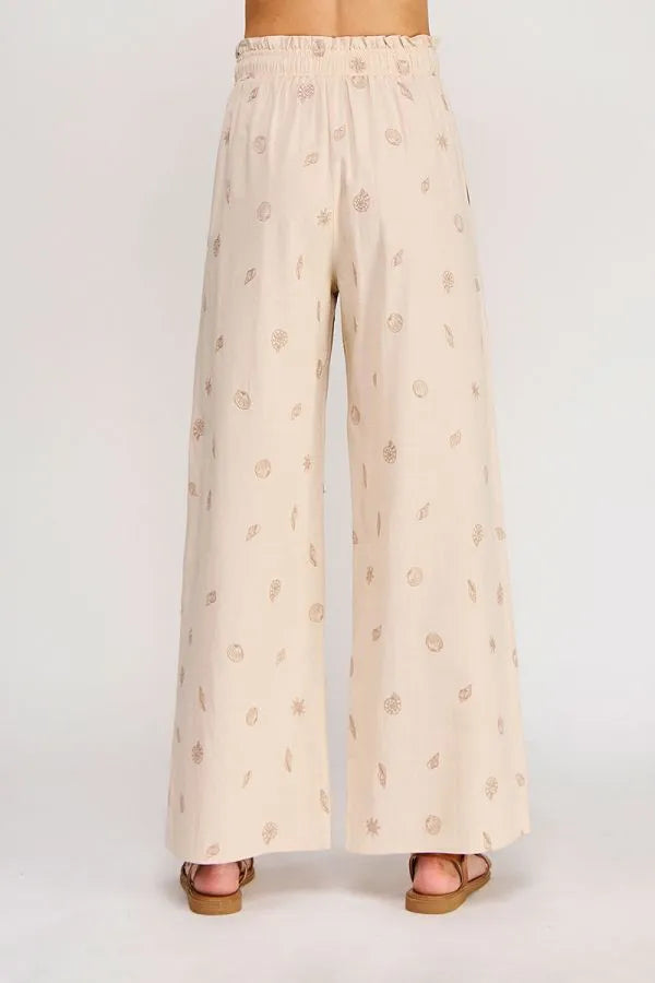 Beige wide-leg seashell ruffle waist elastic tie pants with metallic gold leaf and circular embroidered patterns