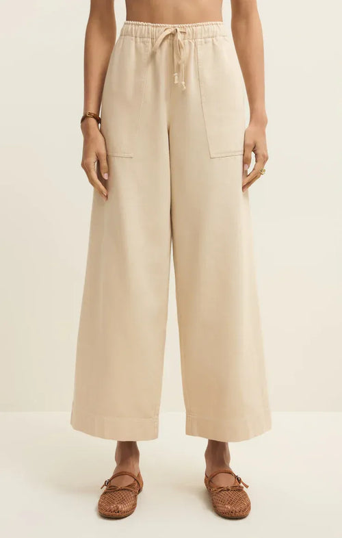 Beige twill wide leg utility pants with a drawstring waist and two front pockets for comfortable wear