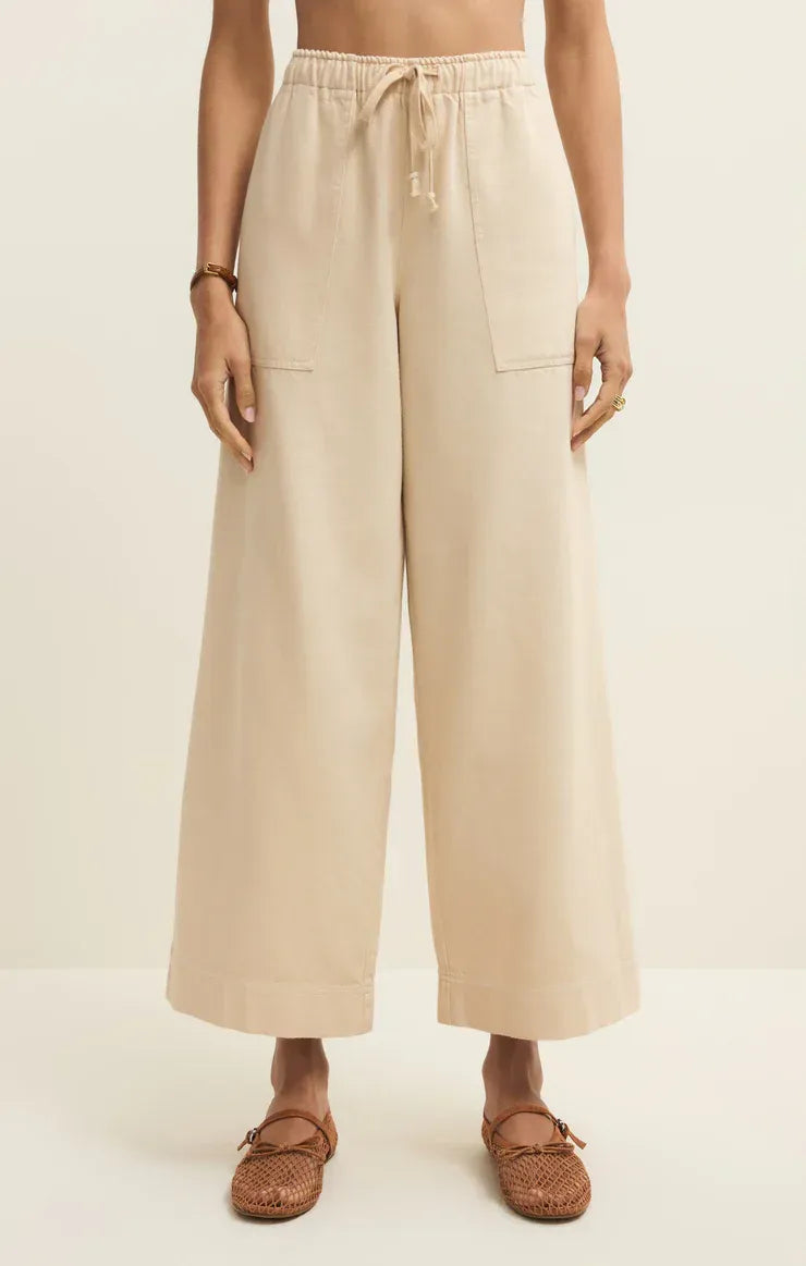 Beige twill wide leg utility pants with a drawstring waist and two front pockets for comfortable wear