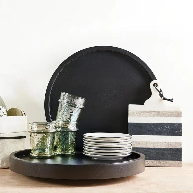 Black circular serving tray with smooth matte finish and raised edges from everyday luster glass green collection
