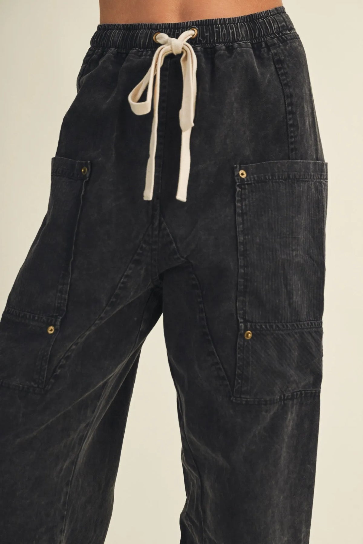 Black corduroy drawstring waist wide leg utility pants with gold-tone button accents and cargo pockets