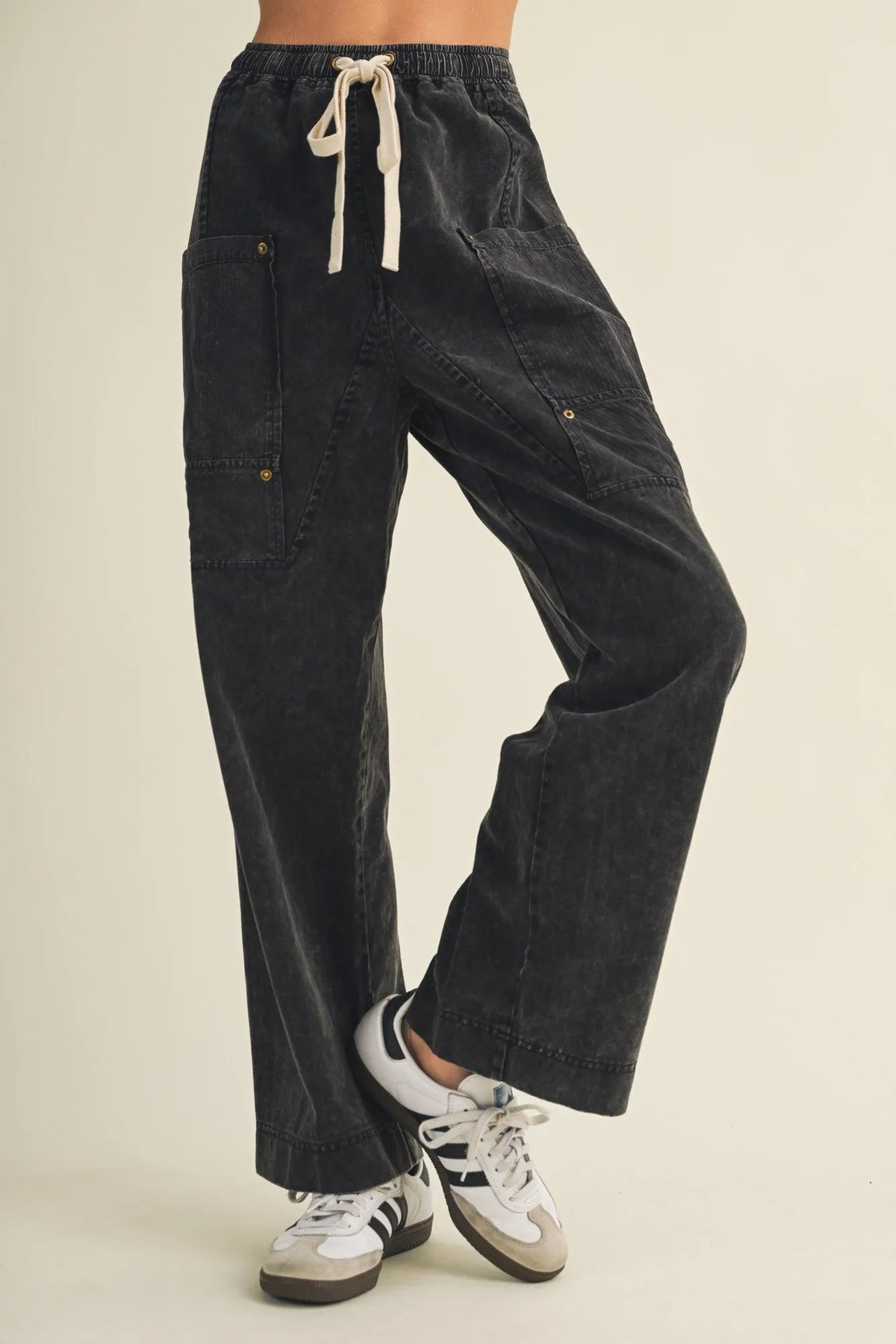 Black corduroy drawstring waist wide leg utility pants with multiple cargo pockets for versatile wear