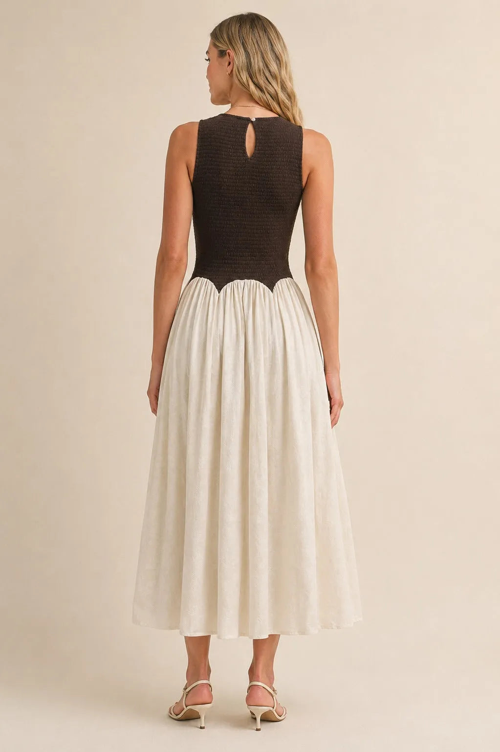 A black and cream sleeveless knit crinkle maxi dress with a textured knit bodice and keyhole back detail