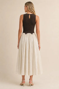 A black and cream sleeveless knit crinkle maxi dress with a textured knit bodice and keyhole back detail