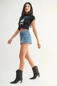 Black cropped graphic tee with colorful cartoon design paired with classic mini denim high rise skort front view