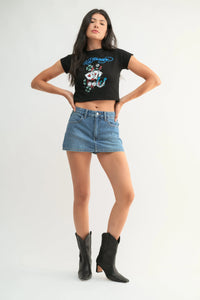 Black cropped t-shirt with colorful ed hardy graphic paired with classic mini denim high rise skort