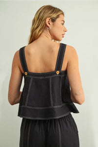 Black denim stitch detailed sleeveless top with white stitching and gold-tone buttons on shoulder straps