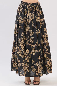 Black drawstring tiered midi skirt with gold botanical print and tiered hem in lightweight fabric