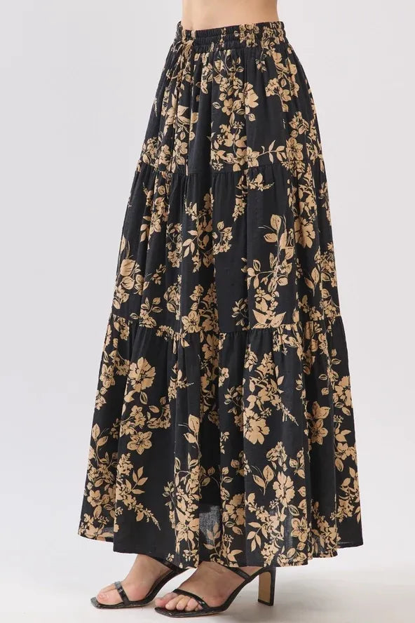 Black drawstring tiered midi skirt with gold botanical print and elastic waistband in lightweight fabric