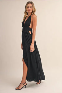 Black crinkle linen maxi dress with halter neck, side cutouts, and high slit perfect as a linen maxi dress option
