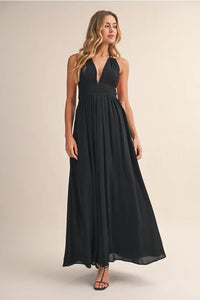 Black halter-neck crinkle linen maxi dress with flowing lightweight fabric and subtle pleating at the waist