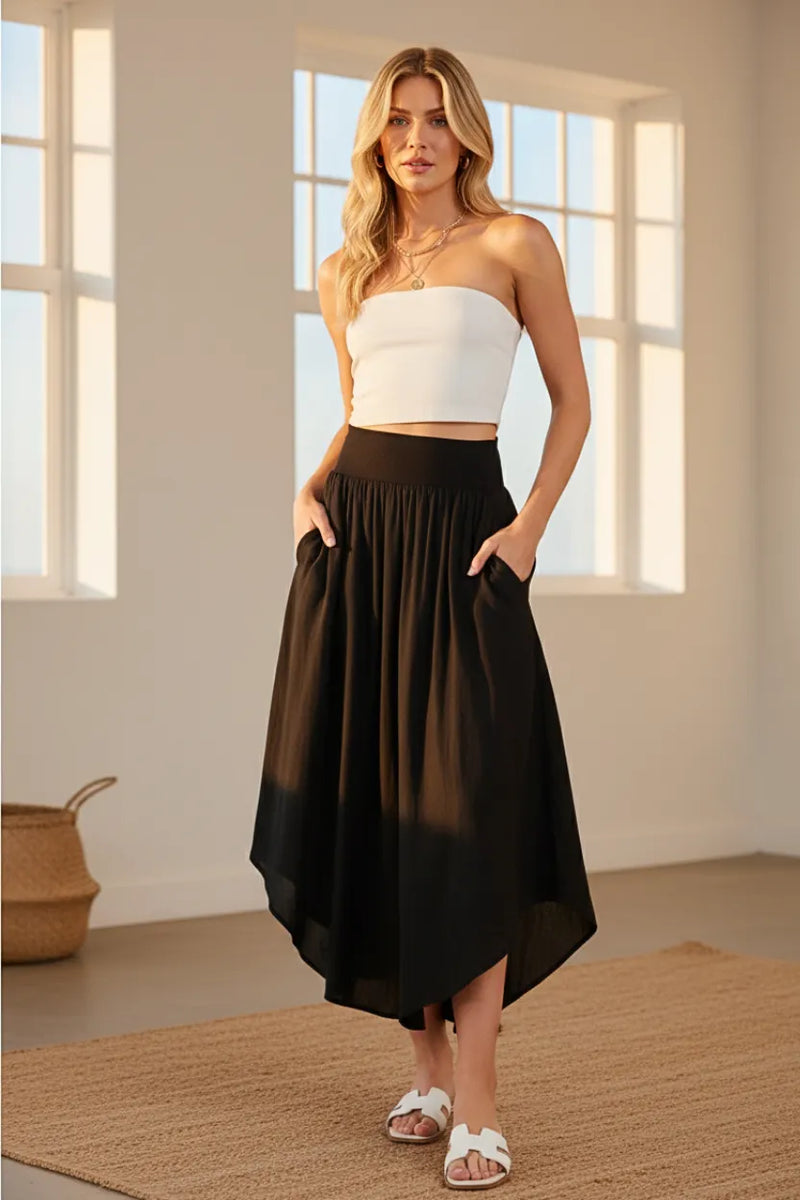 Black flowy smocked waistband midi skirt with sheer asymmetrical overlay