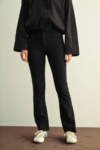 Black slim bootcut jeans with a slim fit, high-waisted flared legs, and subtle frayed hems for ladies