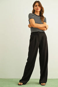 Black high-waisted pleated trousers with stripe ribbed knit top