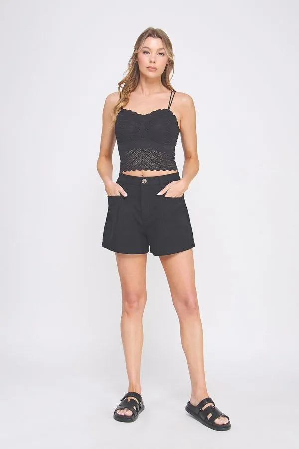 Black lace crop top with thin straps and scalloped hemline featuring a fine lace pattern scallop design