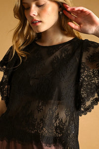 Black lace scalloped blouse with delicate floral patterns and sheer fluttery sleeves for elegant occasions