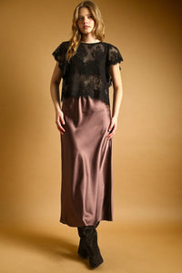 Black lace scalloped blouse with short flutter sleeves paired with a flowing mauve satin skirt