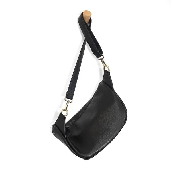 Black leather rory organizer sling belt bag with sleek curved design and silver toned hardware belt bag for hands free use