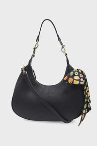 Black leather hobo bag with colorful farmers market scarf tied to the side market scarf convertible crossbody
