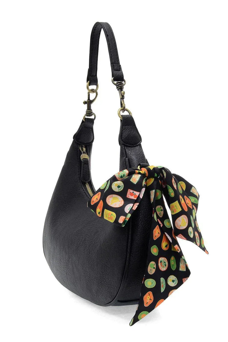 Black leather hobo bag with colorful farmers market scarf tied on handle for market scarf convertible crossbody use