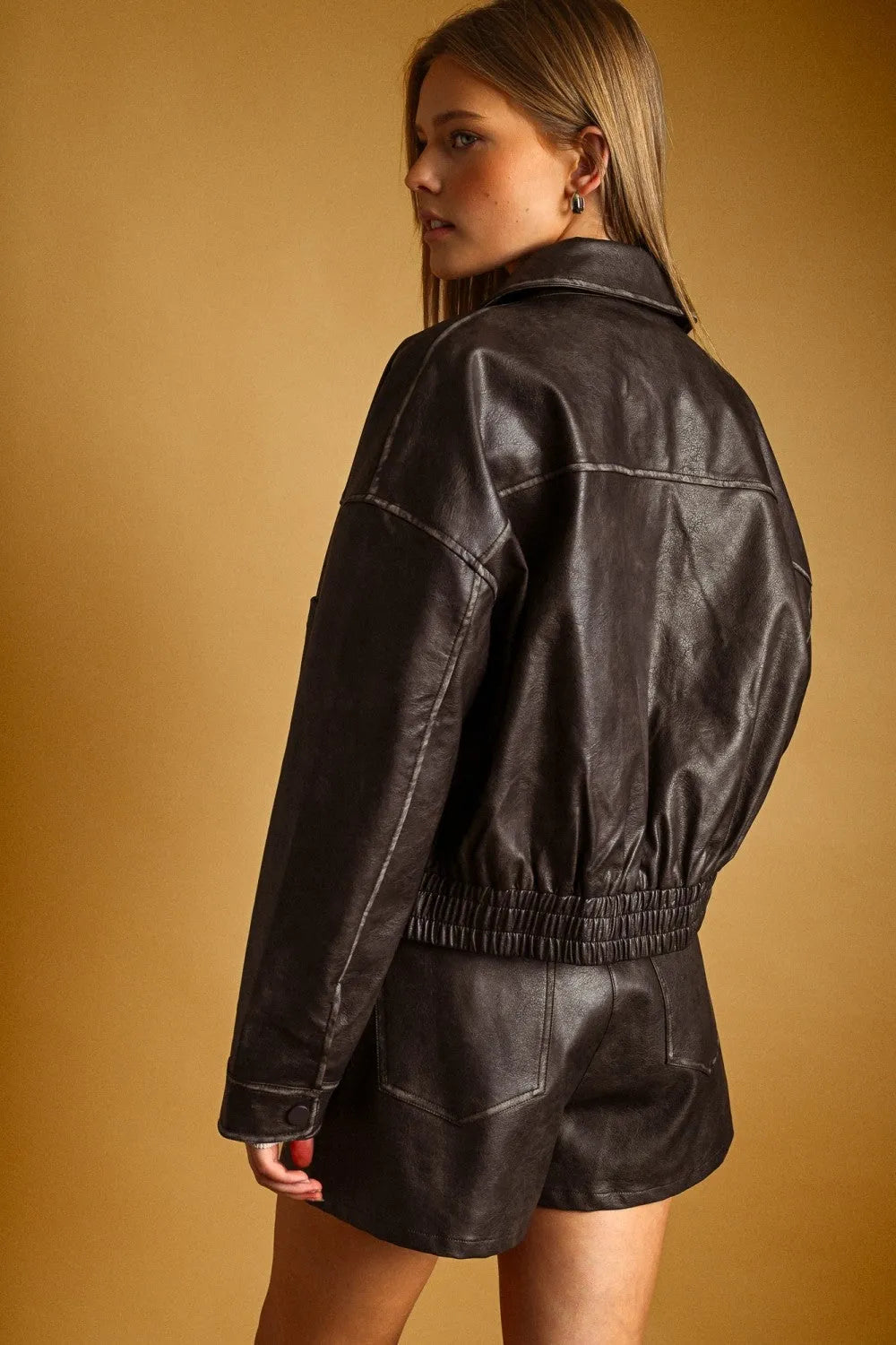 Black leather washed effect button front jacket with elastic waistband and stitched detailing for stylish wear
