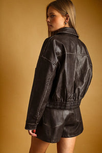 Black leather washed effect button front jacket with elastic waistband and stitched detailing for stylish wear