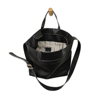Black leather alma buckle tote with patterned interior lining and adjustable shoulder strap for versatile carry
