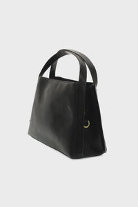 Black leather tote bag with structured shape and minimalist design from the grace satchel crossbody collection