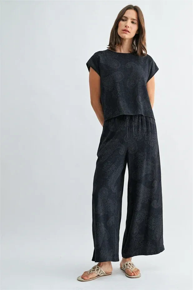 Black linen paisley printed wide shoulder top with matching wide-leg pants set in elegant casual style