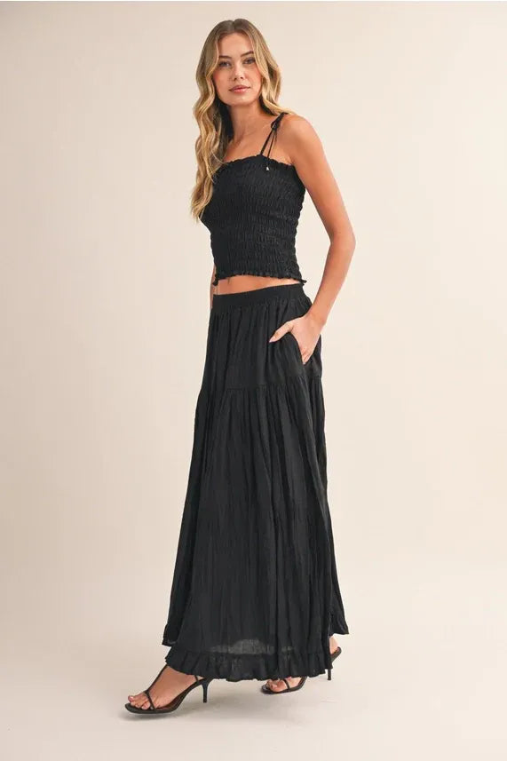 Black crinkled elastic maxi skirt with pleated, flowing layers