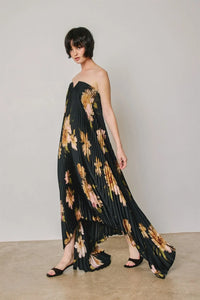 Black floral strapless pleated maxi column dress with gold and peach floral pattern in lightweight fabric