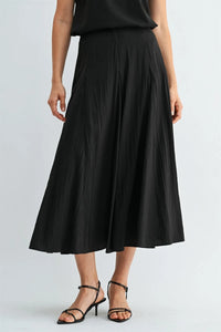Black godet midi skirt with flowing lightweight fabric and side zipper in pleated design for elegant wear