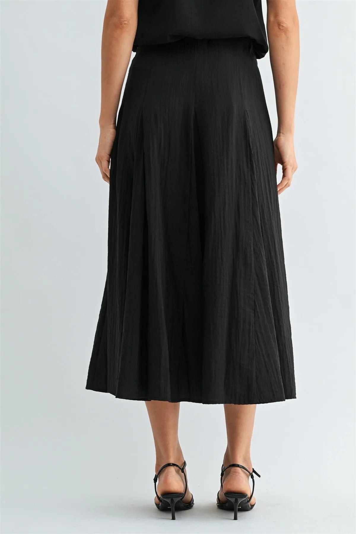 Black godet midi skirt with lightweight pleated fabric and side zipper detailing for elegant wear