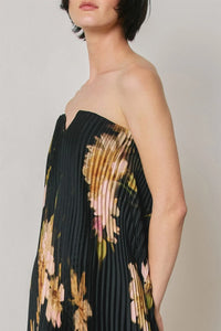 Black floral strapless pleated maxi column dress with soft peach pink and green floral pattern and pleated fabric