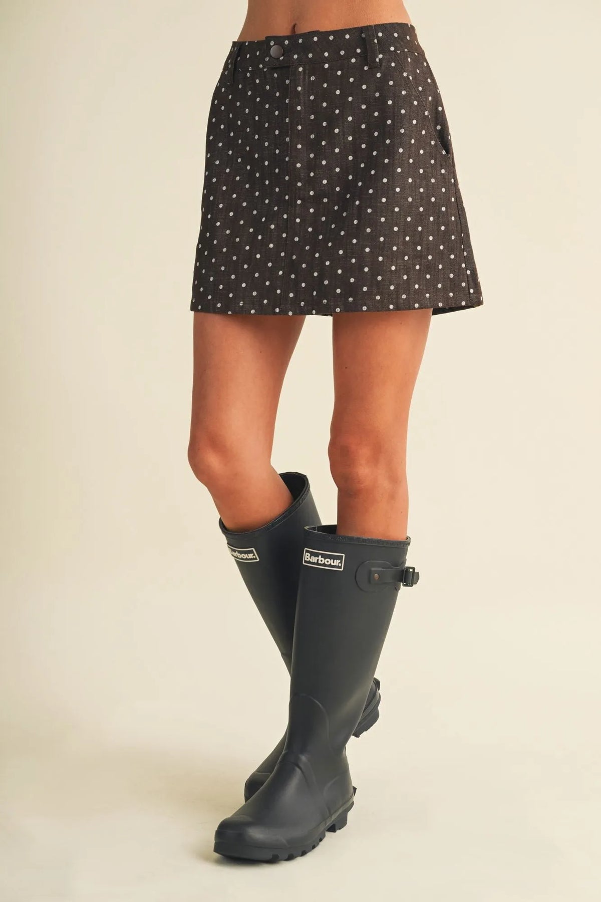 Black polka dot utility skort with white dots and button closure ideal for casual wear