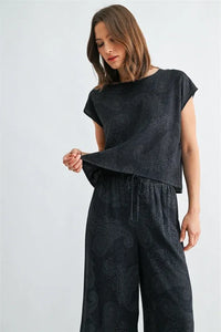 Black short-sleeved paisley printed wide shoulder top made of soft fabric for stylish casual wear