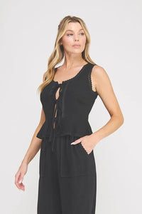 Black sleeveless linen blend jumpsuit with ties lace trim and front tie detail in women’s boho chic clothing style