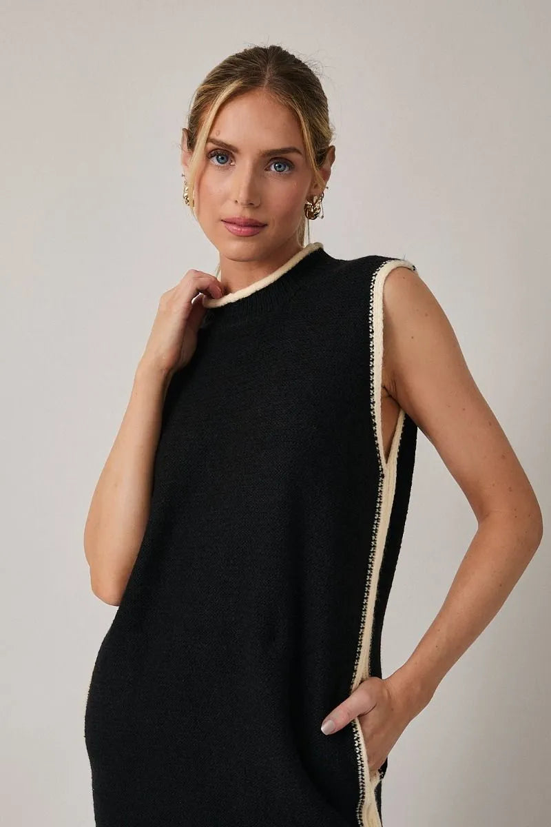 Black mock neck sleeveless sweater dress with cream trim along neckline and side seam in knit fabric