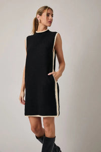 Black sleeveless knit mock neck sweater dress with cream trim along neckline side seams and hem