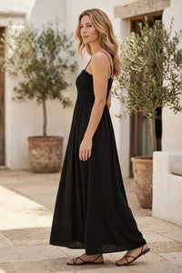 Black sleeveless angel eyes midi dress with thin spaghetti straps and flowing lightweight fabric