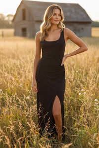 Black sleeveless fitted midi dress with high slit and draped bodice