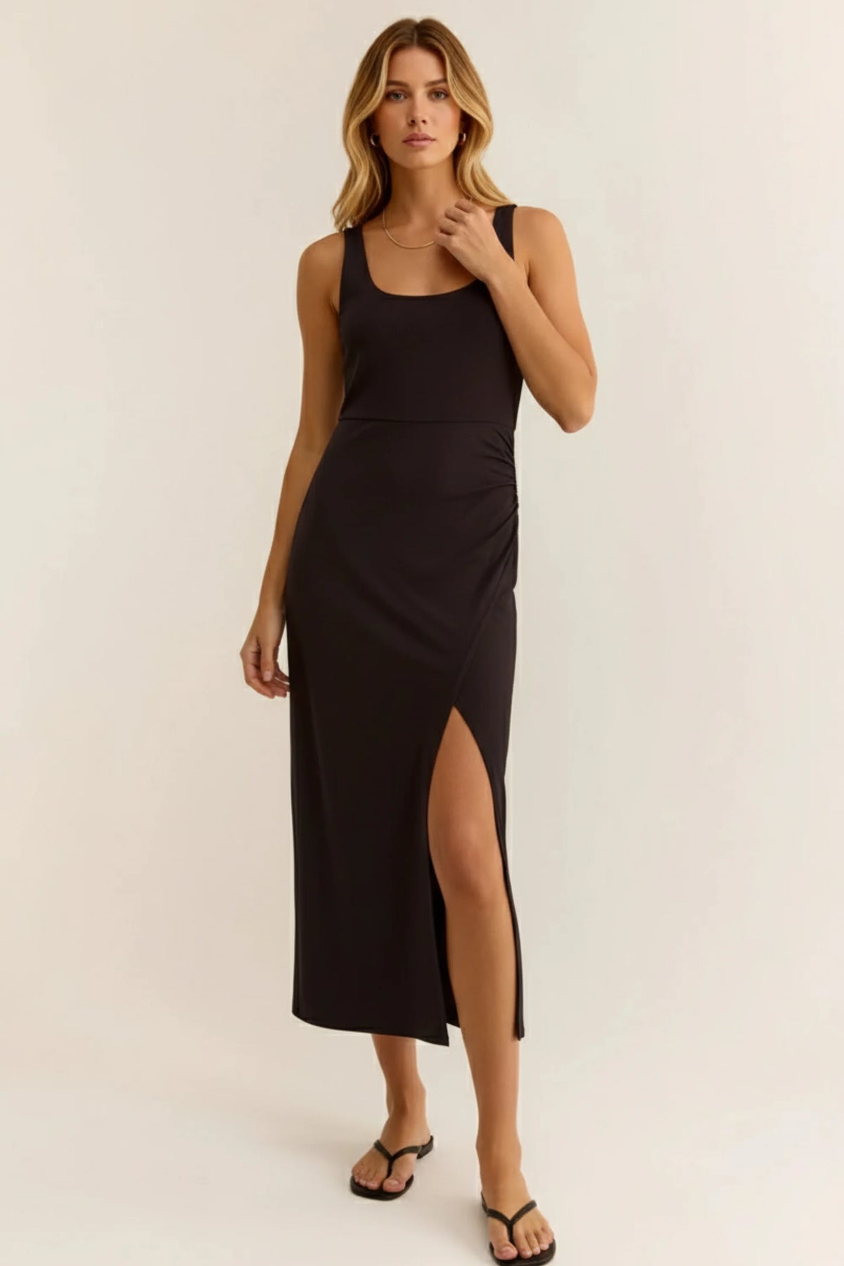 Black sleeveless fitted midi dress with square neckline and high side slit