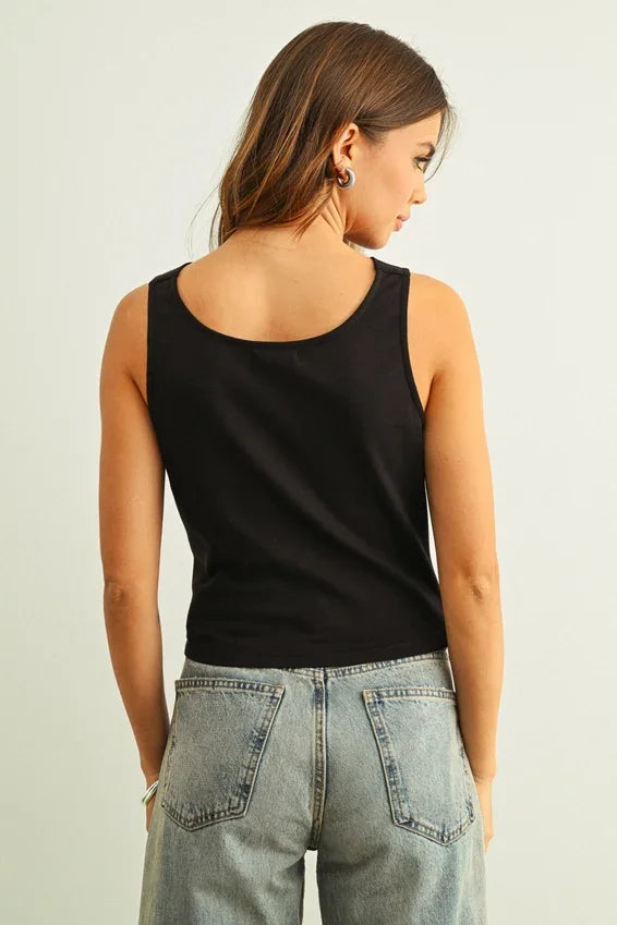 Black cowl neck sleeveless top with rounded neckline and fitted silhouette