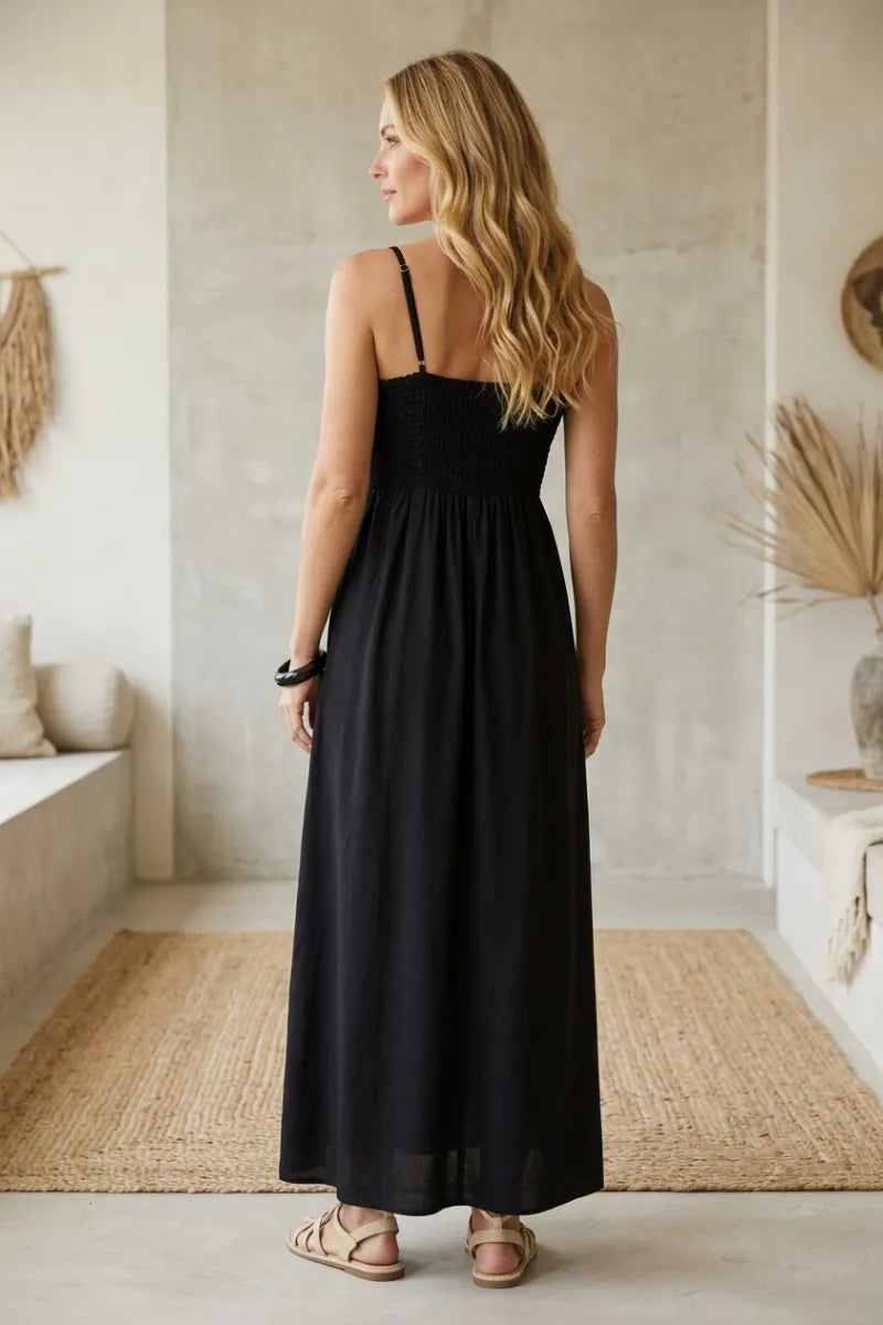 Black angel eyes midi dress with spaghetti straps and gathered waist made of flowing fabric