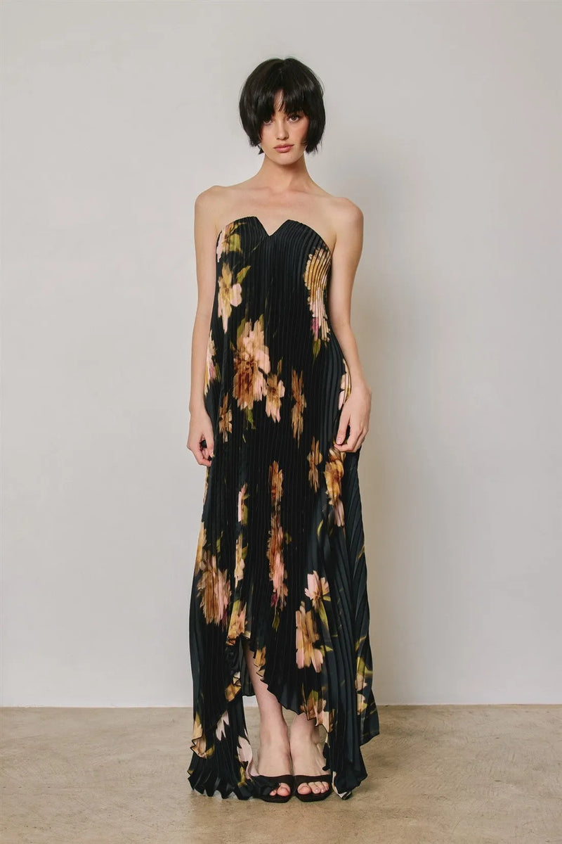 Black floral strapless pleated maxi column dress with peach and brown bold floral pattern and asymmetrical hem